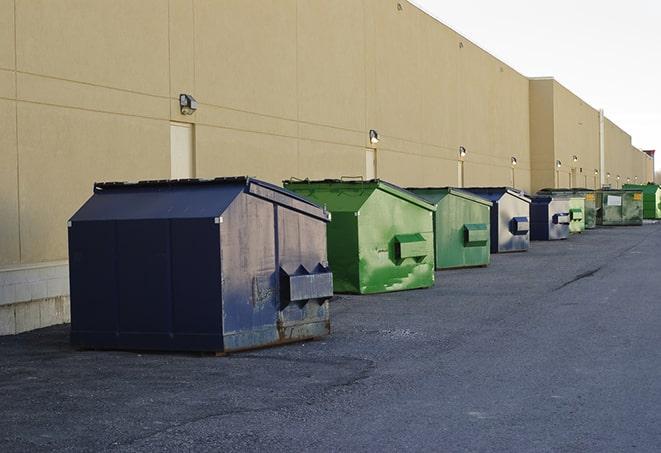 a fleet of red and blue construction dumpsters available for use in Beach City OH